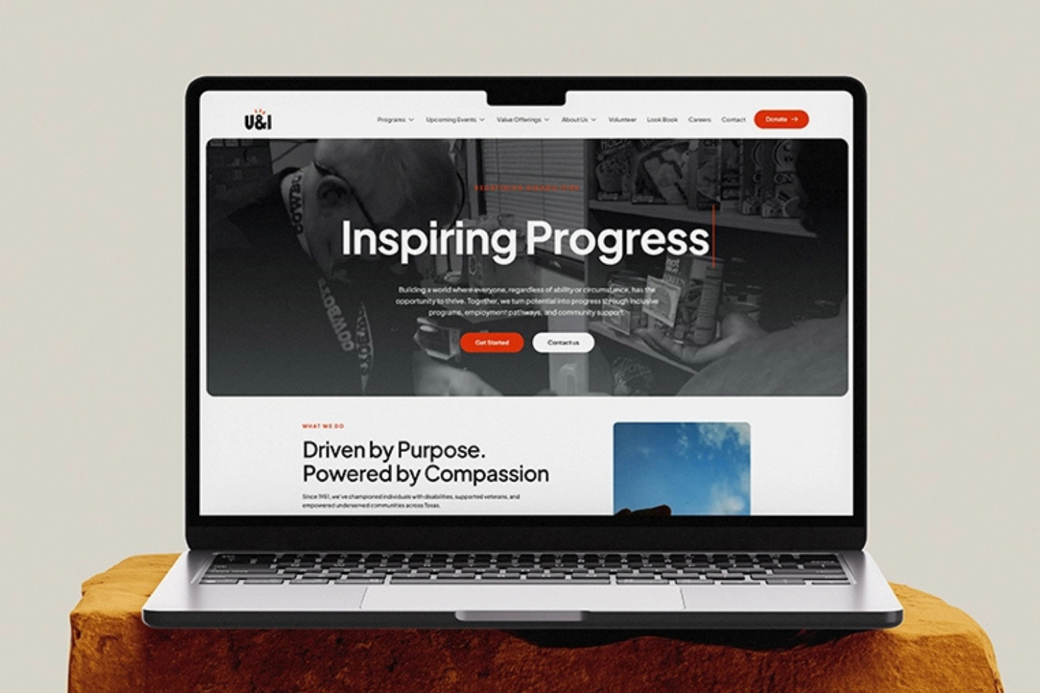 Laptop displaying Inspiring Progress website — creative web and app design by Flinzap