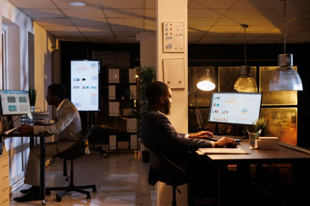 Team analyzing charts and reports in modern office — data-driven market research services by Flinzap